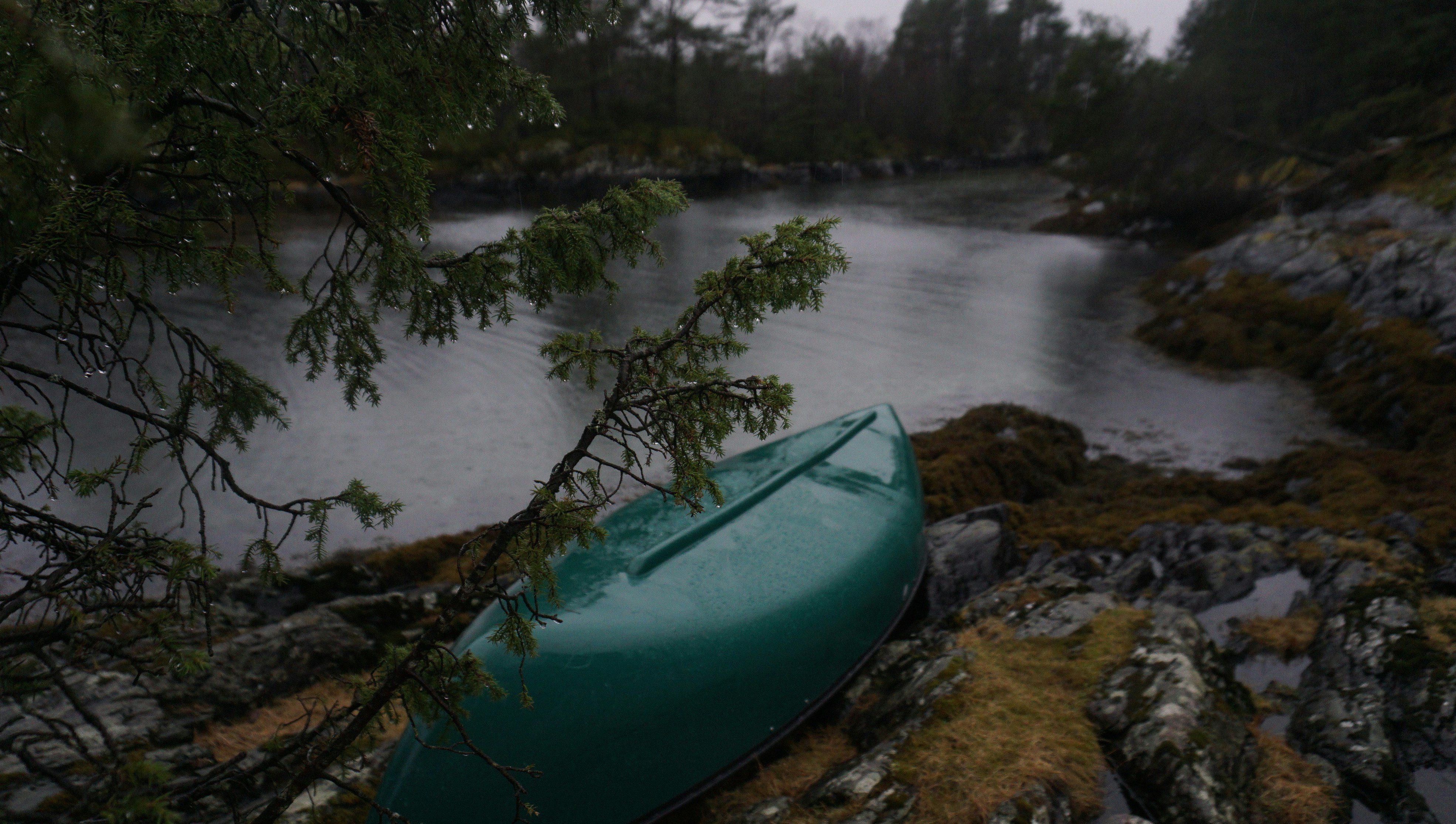 green kayak on rocky river